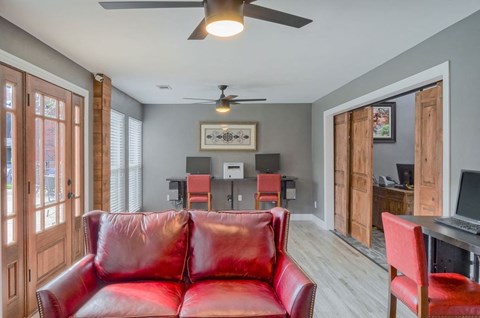 a living room with a red couch and a dining room table